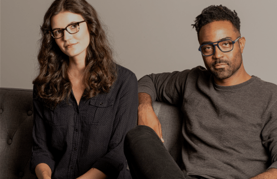 Man and woman sitting on couch wearing North Point Eyewear frames.